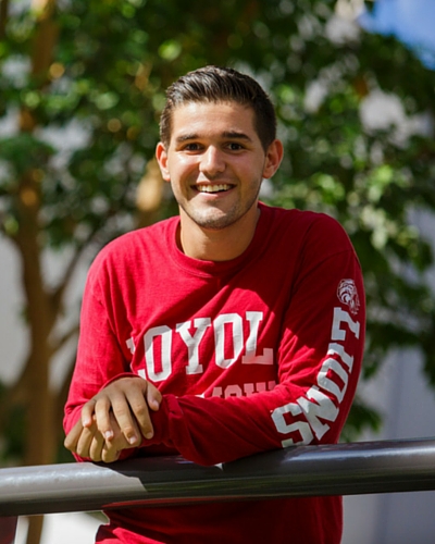 A smiling student wearing an LMU branded shirt